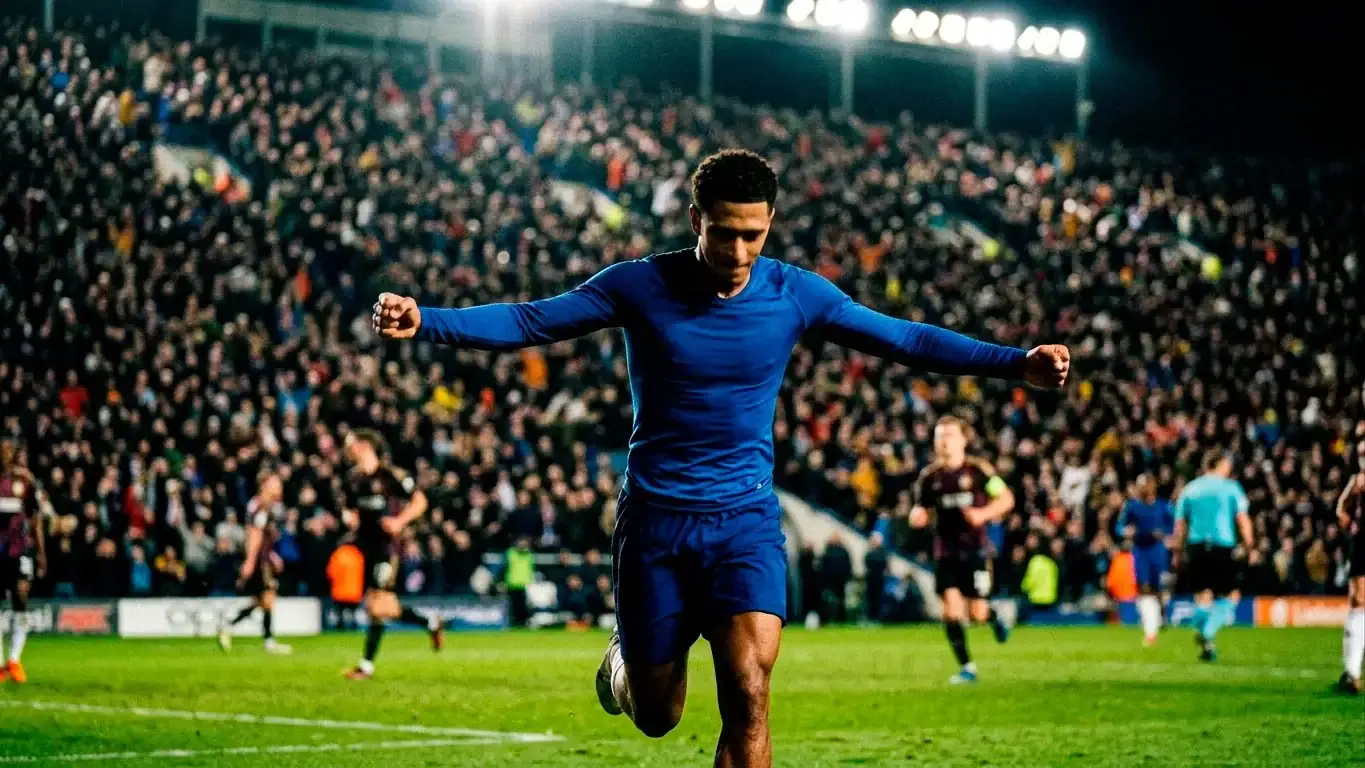 A footballer in a blue shirt celebrating a goal under bright stadium floodlights at night