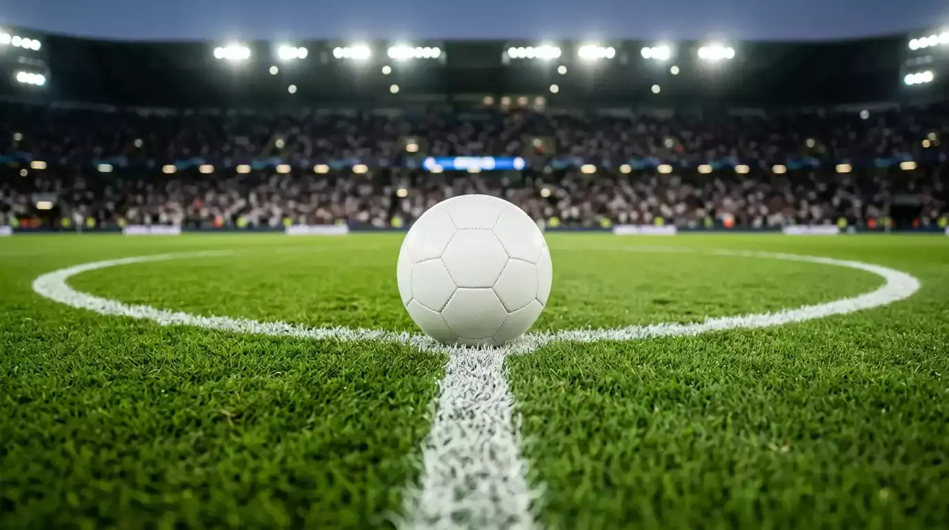 A close-up of a World Cup match ball on the centre spot of a brightly lit pitch